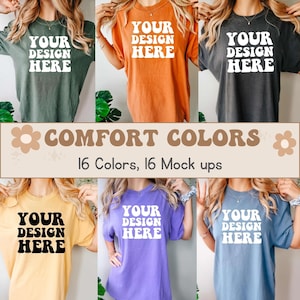 Może przedstawiać: Makieta 16 różnych kolorowych koszulek z nadrukiem "YOUR DESIGN HERE" z przodu. Koszulki są w tym samym stylu i rozmiarze, ale pokazane są w różnych kolorach, w tym zielonym, pomarańczowym, czarnym, żółtym, fioletowym i niebieskim. Tekst "COMFORT COLORS" jest wyświetlany nad koszulkami, wraz z tekstem "16 Kolorów, 16 Makiet".