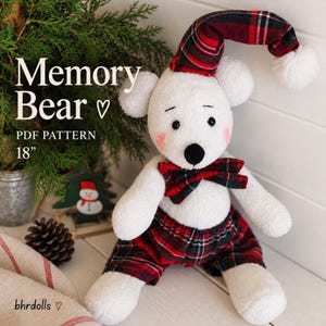 May include: A white plush bear toy wearing red and black tartan shorts, a matching bow tie, and a matching nightcap with a white pom-pom. The bear has black eyes, a black nose, and pink cheeks. Text reads: Memory Bear PDF PATTERN 18 inches.