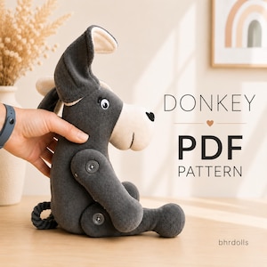 May include: A plush donkey toy made of dark gray fabric with a cream-colored muzzle, long ears, and button joints at the shoulders and hips. The text DONKEY PDF PATTERN and bhrdolls are visible on the right side of the image.