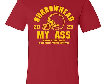 May include: Red t-shirt with a yellow graphic of a football helmet and the text "Burrowhead 20 23 My Ass Know Your Role And Shut Your Mouth"