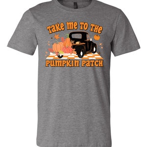 May include: A gray t-shirt with the text "Take me to the pumpkin patch" in orange and black lettering. A black vintage truck with pumpkins in the bed is pictured below the text.