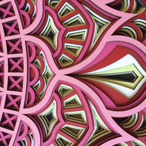K&ouml;nnte beinhalten: Ein mehrschichtiges Kunstwerk mit einem floralen oder Mandala-Muster. Das Kunstwerk verwendet Schattierungen von Rosa, Rot, Wei&szlig; und Gelb und erzeugt einen komplexen, strukturierten Effekt. Es scheint aus geschnittenem Papier oder Holz zu bestehen, mit einem dreidimensionalen Aussehen.