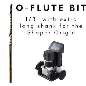 May include: An O-Flute bit, 1/8" with an extra long shank, is displayed next to a black Shaper Origin tool. The text on the image reads "O-FLUTE BIT" and "1/8" with extra long shank for the Shaper Origin."