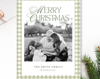 May include: A green and white gingham patterned Christmas card with a black and white photo of a family of three. The text "Merry Christmas" is written in green cursive script. The text "The Smith Family" and "December 2024" is written in black.