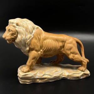 Vintage Ceramic Lion Figurine With Textured Mane & Detailed Body On Rock Base