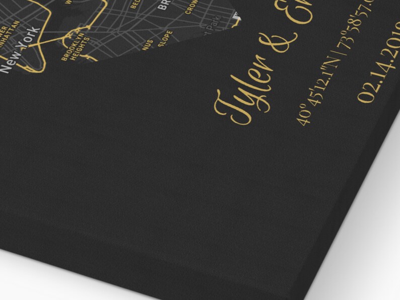 May include: A black and gold map of New York City with the text "Tyler & Emily" and the coordinates "40&deg;45'12.1"N | 73&deg;58'57.0" and the date "02.14.2010".