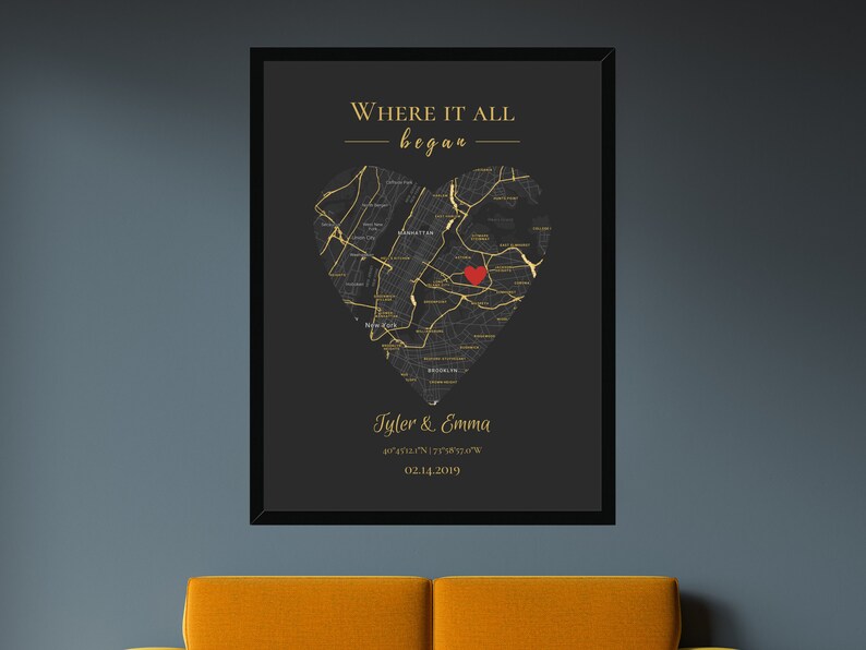 May include: A black and gold print with a heart-shaped map of a city. The text "Where it all began" is at the top of the print. The text "Tyler & Emma" is at the bottom of the print, along with coordinates and a date.