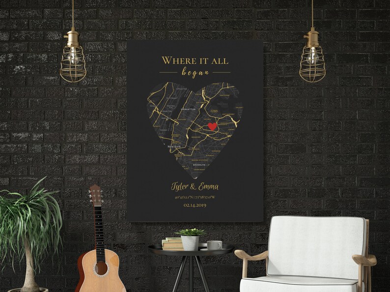 May include: A black and gold canvas print with a heart-shaped map of a city. The text "Where it all began" is at the top of the print. The names "Tyler & Emma" and a date are at the bottom of the print.