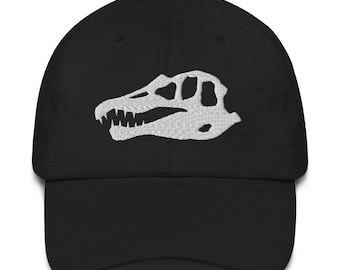 May include: Black baseball cap with a white embroidered dinosaur skull design.