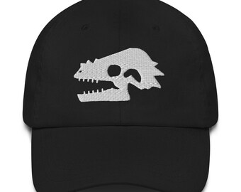 May include: A black baseball cap with a white embroidered dinosaur skull design.