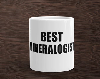 May include: White ceramic coffee mug with black text that reads "BEST MINERALOGIST".