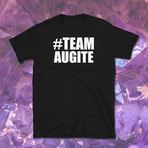 May include: Black t-shirt with white text that reads "#TEAM AUGITE" on a purple background.