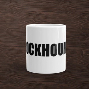 May include: White ceramic coffee mug with the word "BLOODHOUND" printed in black letters.