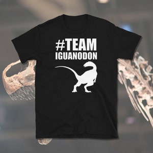 May include: Black t-shirt with a white silhouette of a dinosaur and the text "#TEAM IGUANODON"