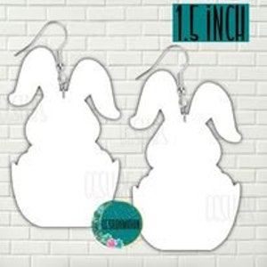 May include: A pair of white bunny rabbit earrings with a 1.5 inch size. The bunny is sitting in an egg.