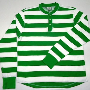 May include: A long-sleeved shirt with white and green horizontal stripes. The shirt has a button-up collar and a single button closure at the neck.