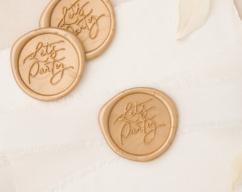 May include: Three gold wax seals with the text "Let's Party" in a cursive font.