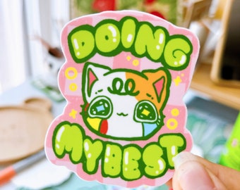 May include: A pink and white sticker with a cartoon cat and the text "Doing My Best" in green letters.