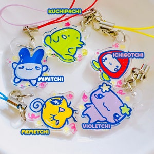 May include: Six colorful character charms with different names, including Kuchipatchi, Mimitchi, Violetchi, and Memeatchi. Each charm is attached to a clear plastic keychain with a metal ring.