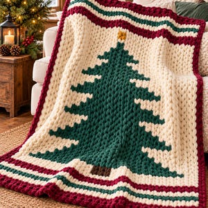 May include: A chunky knit throw blanket featuring a large dark green Christmas tree design centered on a cream background. The blanket is bordered by thick stripes of deep red and dark green, with a small yellow star at the tree top.