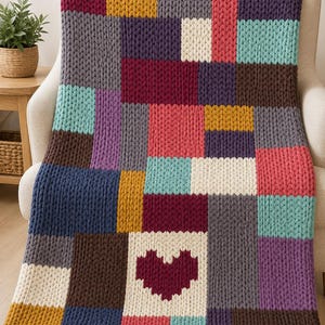 May include: A chunky knit throw blanket featuring a patchwork design of rectangular blocks in various colors including mustard yellow, dark red, navy blue, cream, teal, purple, and gray, with a prominent dark red heart shape in the lower center.