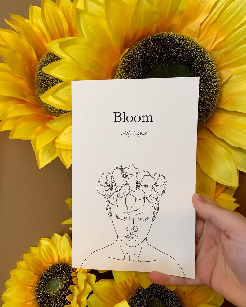A line art style woman wearing a hibiscus flower crown- titled Bloom by Ally Loyns