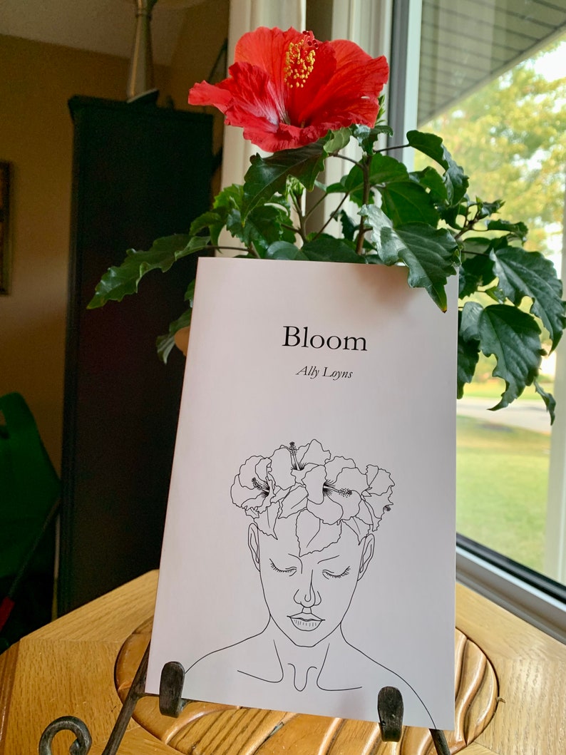 A line art style woman wearing a hibiscus flower crown- titled Bloom by Ally Loyns