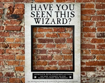 May include: A white poster with black text that reads "Have you seen this wizard?" with a cutout for a face. The poster is attached to a brick wall. The text below the cutout reads "Approach with extremecaution! Do not attempt to use magic against this person!"