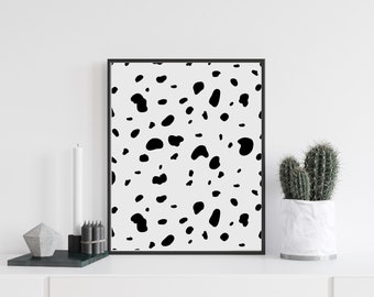 Peut inclure: Impression d'art encadrée en noir et blanc avec un motif de taches de dalmatien. L'œuvre est affichée sur un mur blanc, avec une bougie blanche, un récipient géométrique et un cactus dans un pot blanc.
