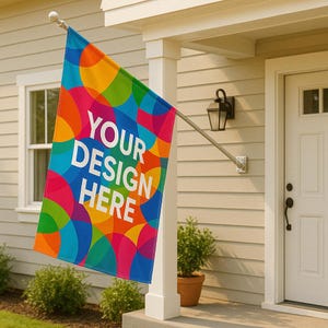 May include: A colorful outdoor flag with the text "YOUR DESIGN HERE" in white. The flag features a vibrant pattern of overlapping circles in shades of blue, orange, yellow, green, and pink. The flag is mounted on a metal pole and displayed outside a house.
