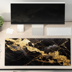 May include: Black and gold marble desk mat with a modern design. The mat is on a light wood desk with a computer monitor, keyboard, mouse, and a potted plant.