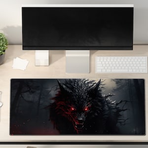 May include: A black and white mousepad with a dark wolf with glowing red eyes in a dark forest setting.