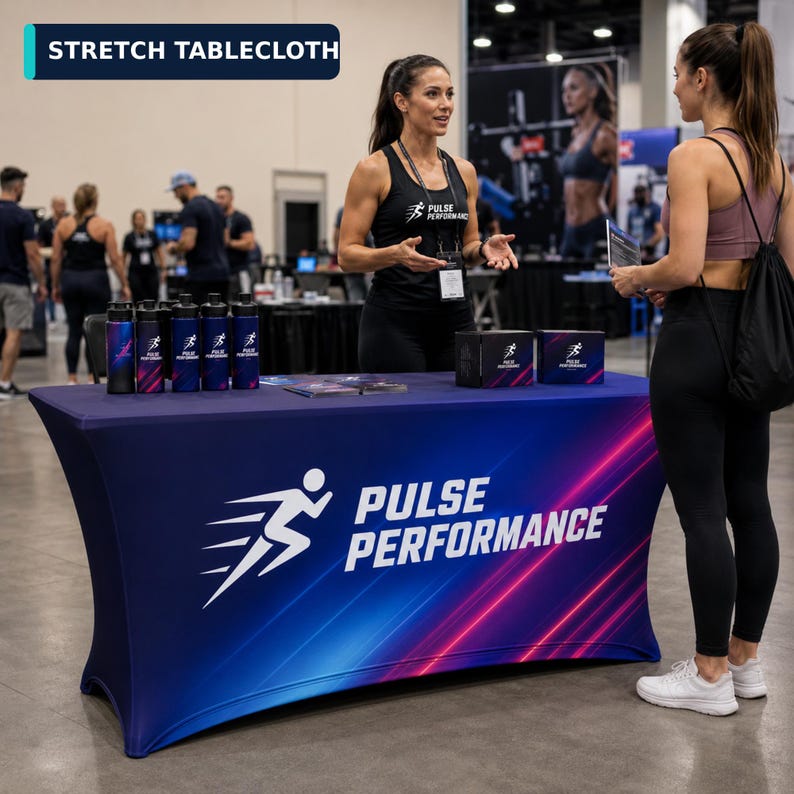 May include: A rectangular stretch tablecloth featuring a dark blue background with diagonal red and blue light streaks. The text "PULSE PERFORMANCE" is printed in white alongside a white graphic of a running figure on the front panel.