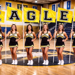 May include: Six cheerleaders in black and gold uniforms stand holding flags that spell out "EAGLES". The flags are yellow with black block letters. The cheerleaders are in a gymnasium.