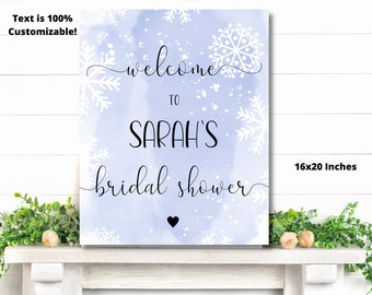 May include: A light blue watercolour background with white snowflakes and the text "Welcome to Sarah's Bridal Shower" in black cursive font. The sign is 16x20 inches.