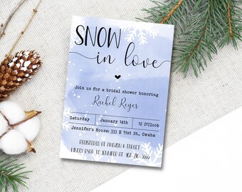 May include: A blue and white bridal shower invitation with snowflakes and the text "SNOW in love". The invitation is for Rachel Reyes and is scheduled for Saturday, January 14th at 12 o'clock at Jennifer's House: 333 E 51st St., Omaha. The invitation also includes the text "REGISTERED AT AMAZON & TARGET" and "KINDLY RSVP TO JENNIFER AT 402-216-5555".