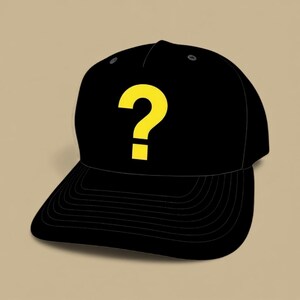 May include: Black baseball cap with a yellow question mark on the front. The cap has a curved brim and a structured crown. The background is a solid tan color. This hat is a stylish accessory.