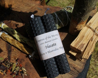 May include: Two black beeswax candles with a label that reads "Empress of the Moon" 100% Beeswax Candles Hecate Protection - Neutralise Negativity"