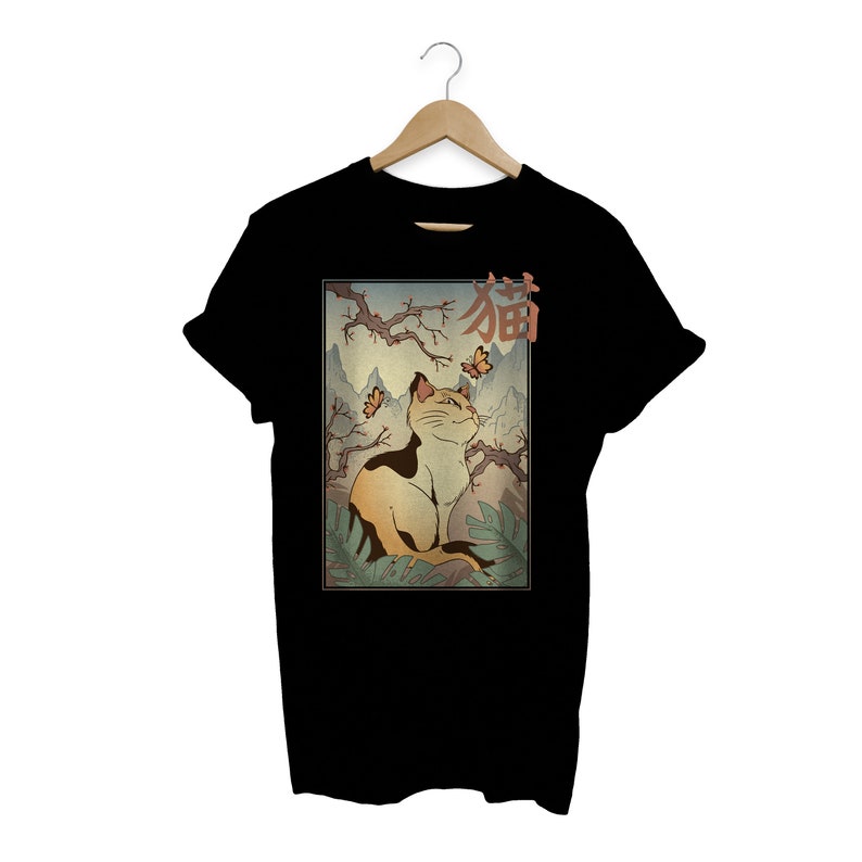 May include: Black t-shirt with a graphic of a cat sitting in a Japanese garden with the word "猫" (cat in Japanese) above it.