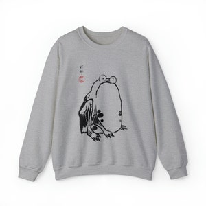May include: A gray sweatshirt with a black and white illustration of a frog with the Japanese word "蛙" (meaning frog) in red ink.