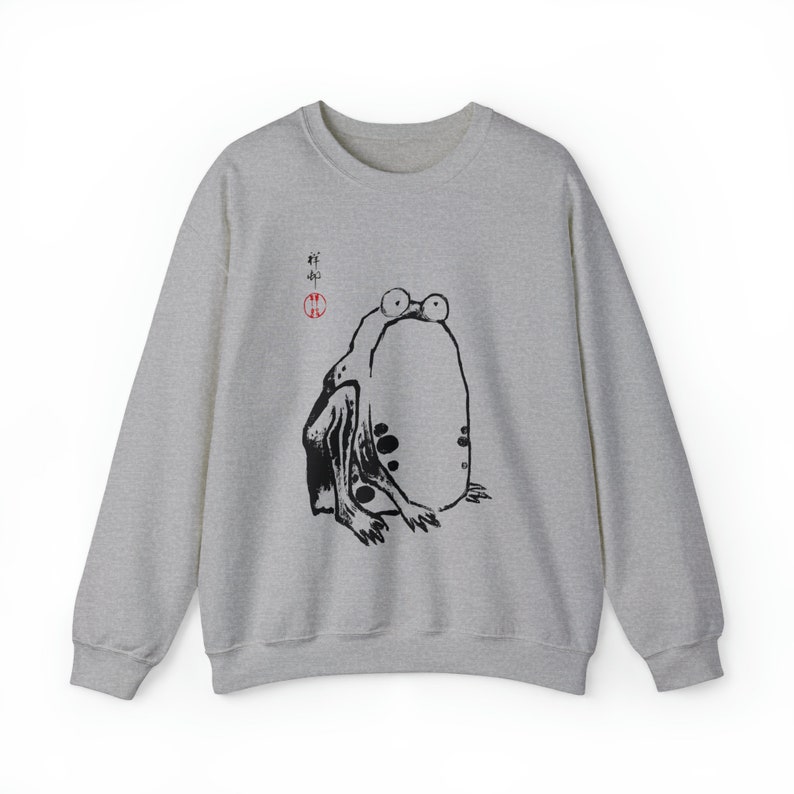May include: A gray sweatshirt with a black and white illustration of a frog with the Japanese word "蛙" (meaning frog) in red ink.