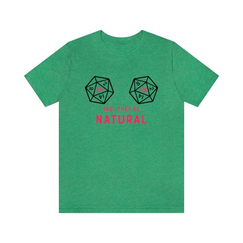 May include: Green t-shirt with a graphic of two 20-sided dice with the number 20 showing on each die. The text "YES, THEY'RE NATURAL" is printed below the dice.