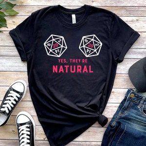 May include: Black t-shirt with a white graphic of two 20-sided dice and the text "YES, THEY'RE NATURAL".