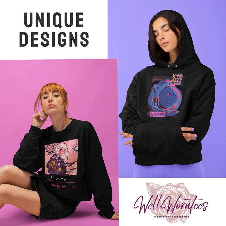 May include: Two models are wearing black sweatshirts with unique graphic designs. The first sweatshirt features a pink and white anime-style illustration of a girl with a cherry blossom background. The second sweatshirt features a blue and pink illustration of a cat wearing a space helmet with Japanese text. Both sweatshirts have the text "Well Worntees" on the bottom.