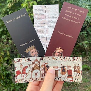May include: Three bookmarks featuring historical figures from the Norman Conquest of England. The bookmarks are red, black and brown with gold accents. The text on the bookmarks includes quotes from the figures and historical dates. The bookmarks are displayed against a green background.