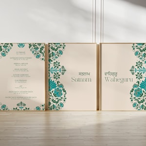 May include: Three framed prints with a cream background and teal floral designs. The left print features a text-based mantra in English and Punjabi. The center print features the word "Satnam" in Punjabi. The right print features the word "Waheguru" in Punjabi.