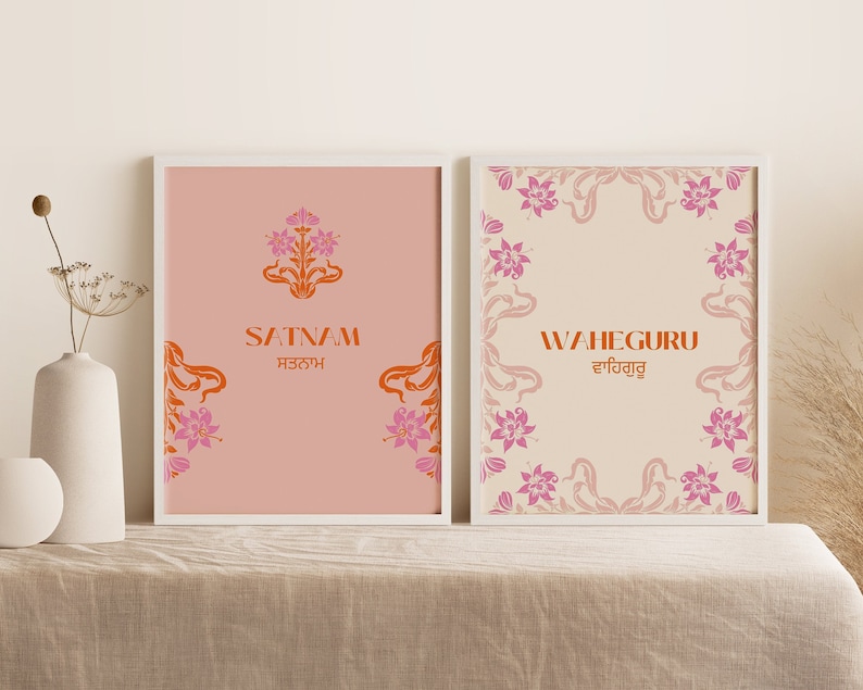 May include: Two framed prints with a pink and orange floral design. The left print says "Satnam" in English and Gurmukhi script. The right print says "Waheguru" in English and Gurmukhi script.