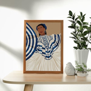 May include: A framed illustration of a woman wearing a white and blue striped dress with a blue and white striped umbrella. The woman has dark skin and is wearing blue earrings. The background is a light brown colour.