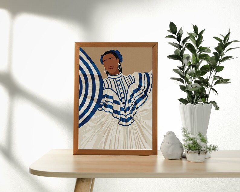 May include: A framed illustration of a woman wearing a white and blue striped dress with a blue and white striped umbrella. The woman has dark skin and is wearing blue earrings. The background is a light brown colour.
