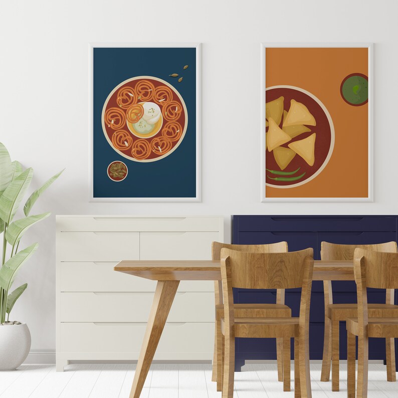 May include: Two framed illustrations of Indian food. The first illustration shows a plate of jalebi with a white sweet on top, surrounded by a red sauce. The second illustration shows a plate of samosas with a green chutney on the side.